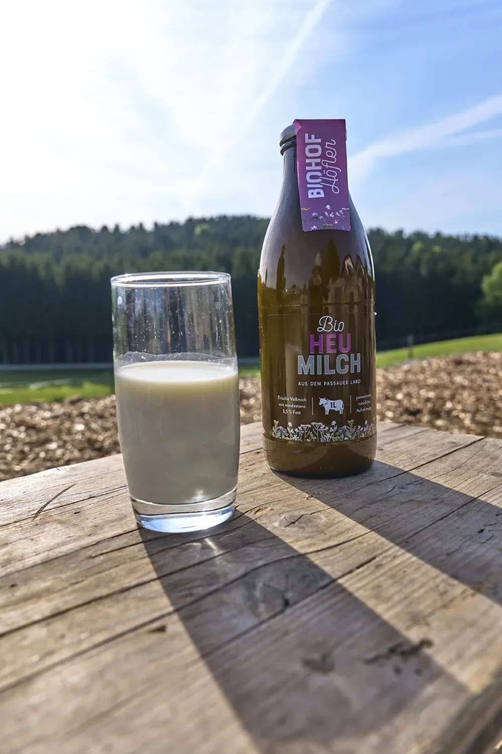 Bio-Heumilch vom Höflerhof auf einem Holztisch